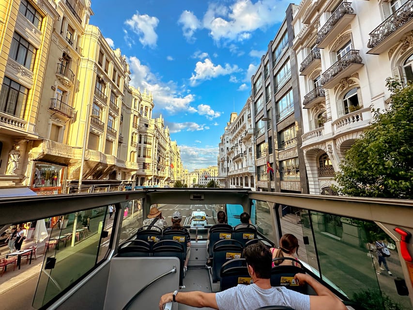 Madrid: Open-Top Big Bus Sightseeing Tour with Live Guide - Royal Palace, Almudena Cathedral, and Puerta de Alcalá from street-level icons